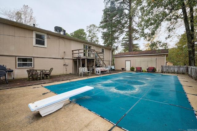 view of pool featuring a diving board and a patio area