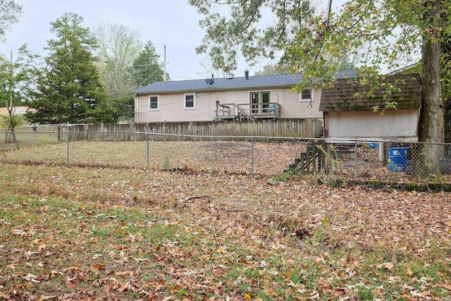 back of property featuring a wooden deck