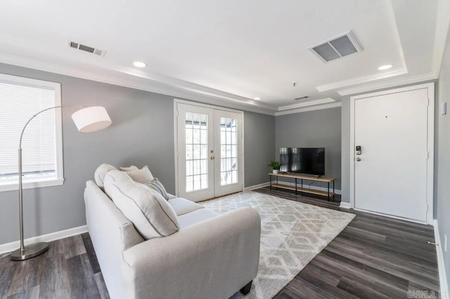 living room featuring french doors, plenty of natural light, dark wood-type flooring, and crown molding