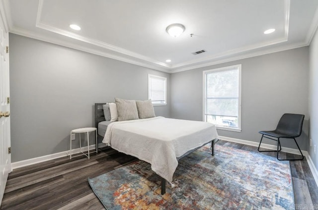 bedroom with ornamental molding and dark hardwood / wood-style floors