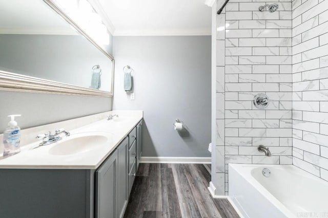 bathroom with tiled shower / bath combo, vanity, hardwood / wood-style flooring, and crown molding