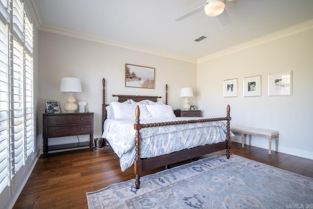 bedroom featuring ornamental molding, multiple windows, dark hardwood / wood-style floors, and ceiling fan