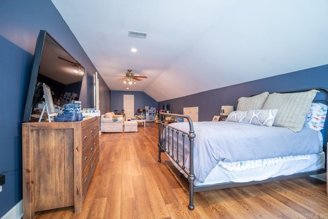 bedroom with light wood-type flooring, vaulted ceiling, and ceiling fan