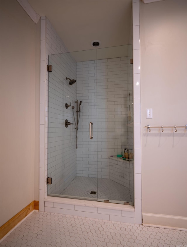 bathroom with walk in shower and tile patterned flooring