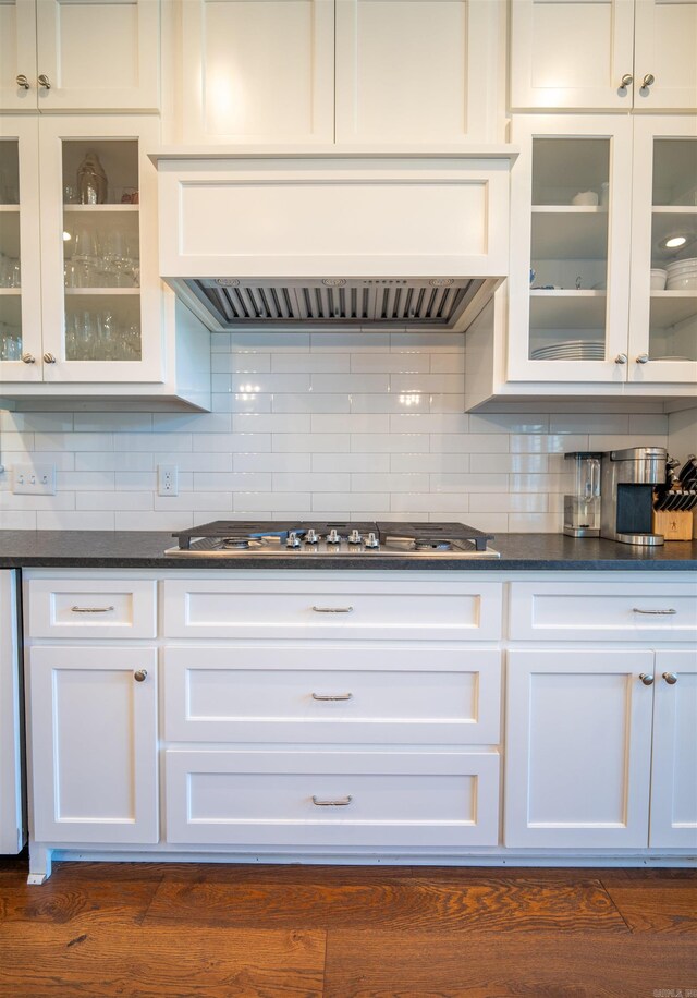 kitchen with white cabinets, backsplash, and dark hardwood / wood-style flooring