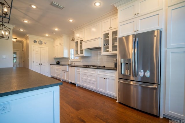 kitchen featuring white cabinetry, crown molding, dark hardwood / wood-style floors, and stainless steel appliances