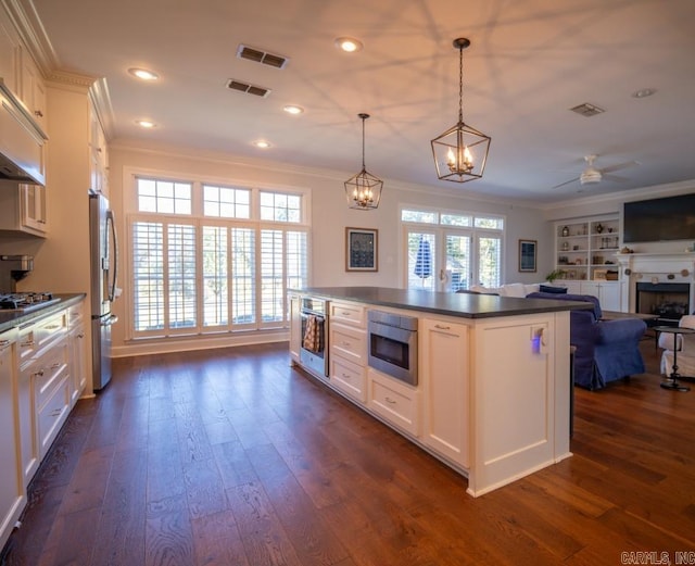 kitchen with dark hardwood / wood-style floors, white cabinetry, and appliances with stainless steel finishes