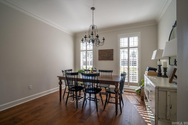 dining room featuring dark hardwood / wood-style flooring, a chandelier, and crown molding