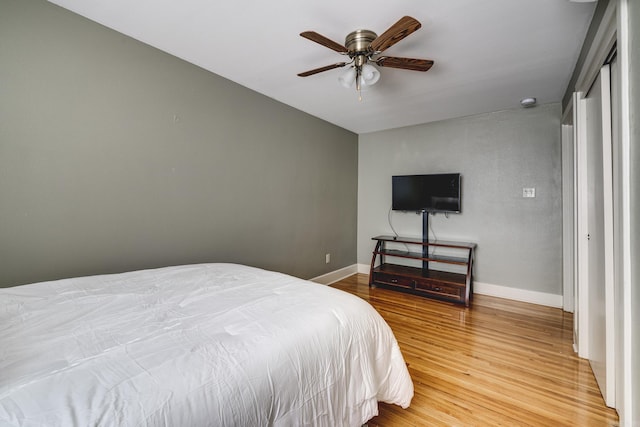 bedroom with wood-type flooring and ceiling fan