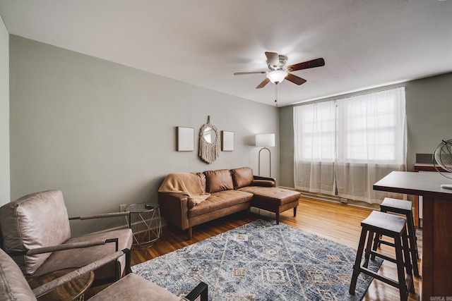 living room featuring wood-type flooring and ceiling fan