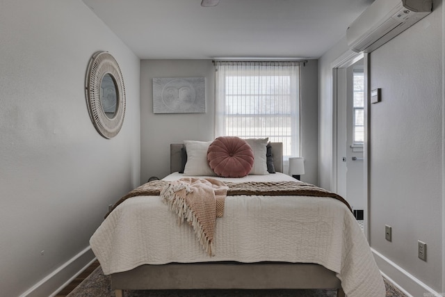 bedroom featuring an AC wall unit