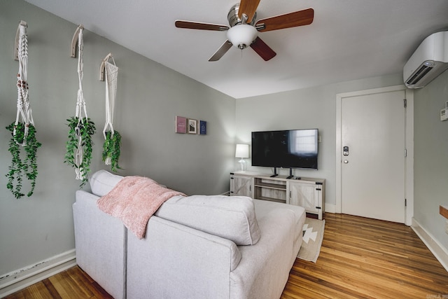 living room featuring an AC wall unit, hardwood / wood-style floors, and ceiling fan