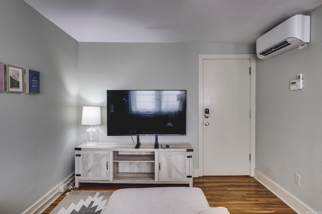 living room featuring a wall unit AC and dark hardwood / wood-style floors