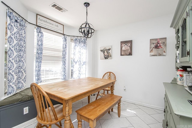 tiled dining space featuring a notable chandelier