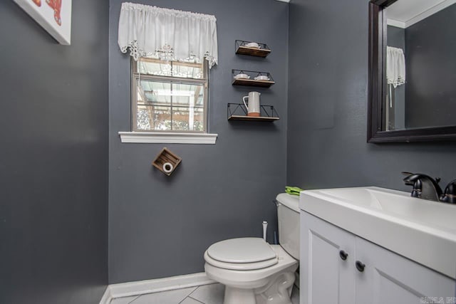 bathroom with tile patterned flooring, vanity, and toilet