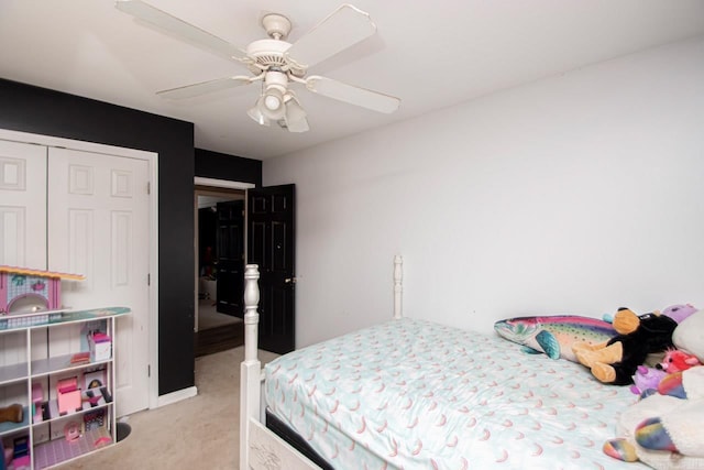 carpeted bedroom featuring ceiling fan and a closet