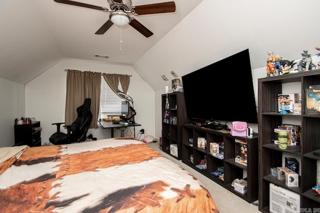 carpeted bedroom with ceiling fan and vaulted ceiling