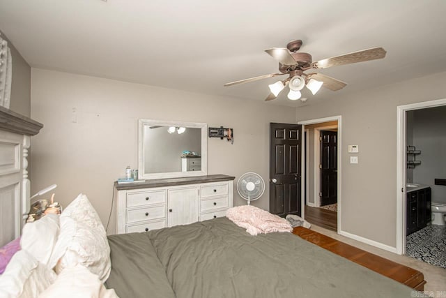 bedroom with ensuite bath and ceiling fan