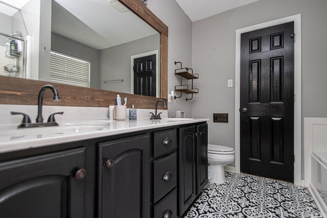 bathroom featuring tile patterned flooring, vanity, and toilet