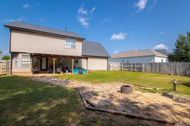 back of property with a lawn and a patio