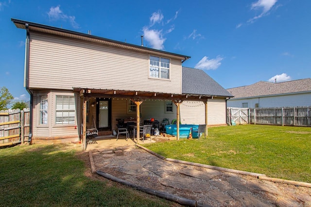 back of property featuring a patio area and a lawn