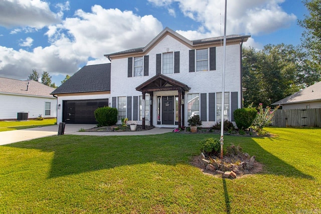 view of front of property with central AC, a front lawn, and a garage