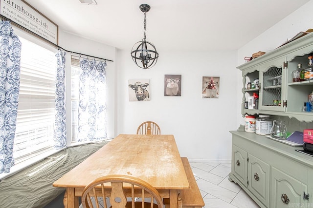 dining area with a wealth of natural light, a chandelier, and light tile patterned flooring