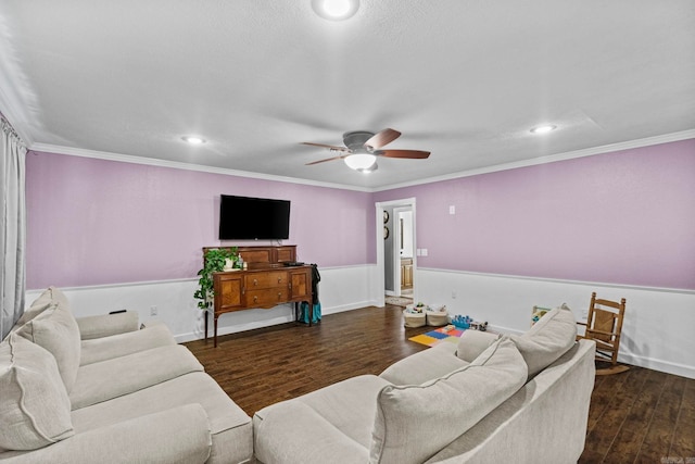 living room featuring dark wood-type flooring, ornamental molding, and ceiling fan