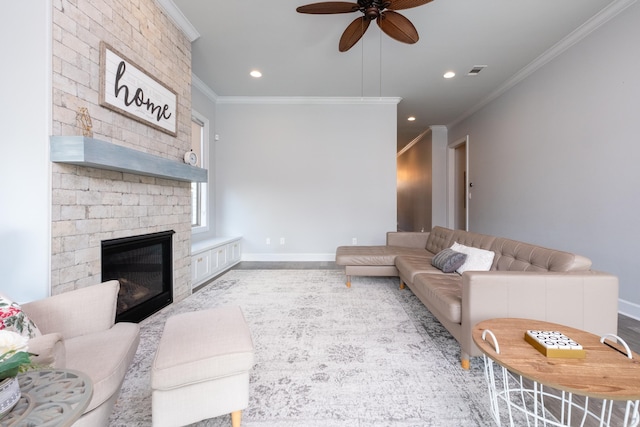 living room featuring a fireplace, ceiling fan, and ornamental molding