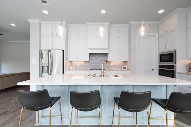 kitchen featuring sink, white cabinetry, appliances with stainless steel finishes, and a large island