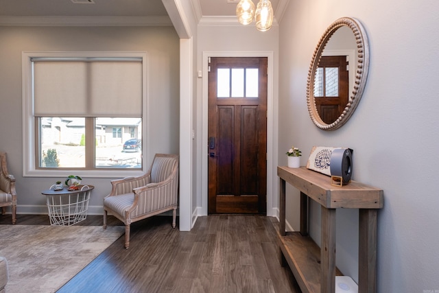 foyer entrance with dark hardwood / wood-style floors and crown molding