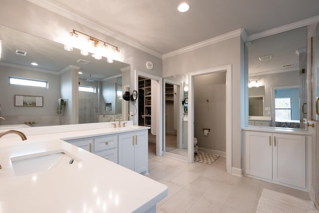 bathroom with toilet, tile patterned flooring, vanity, crown molding, and walk in shower