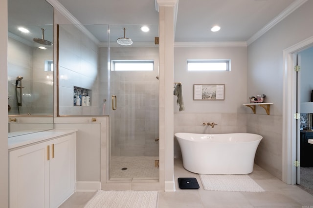 bathroom with ornamental molding, tile walls, shower with separate bathtub, and tile patterned floors