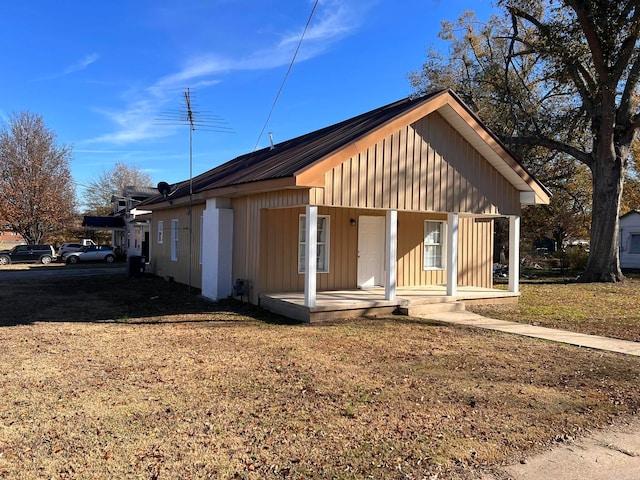 view of home's exterior featuring a porch and a yard