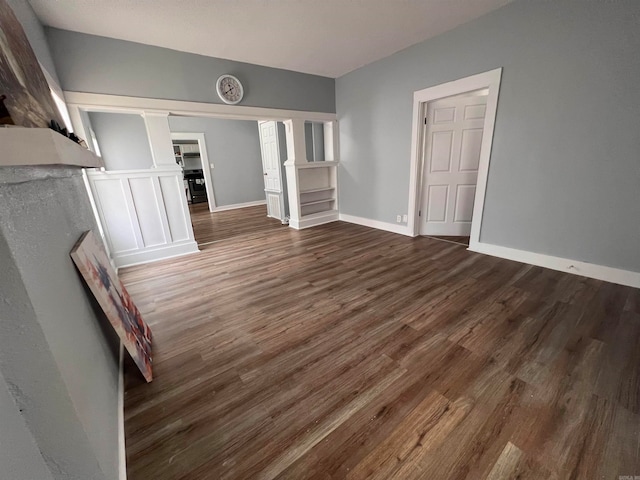 unfurnished living room featuring dark wood-type flooring