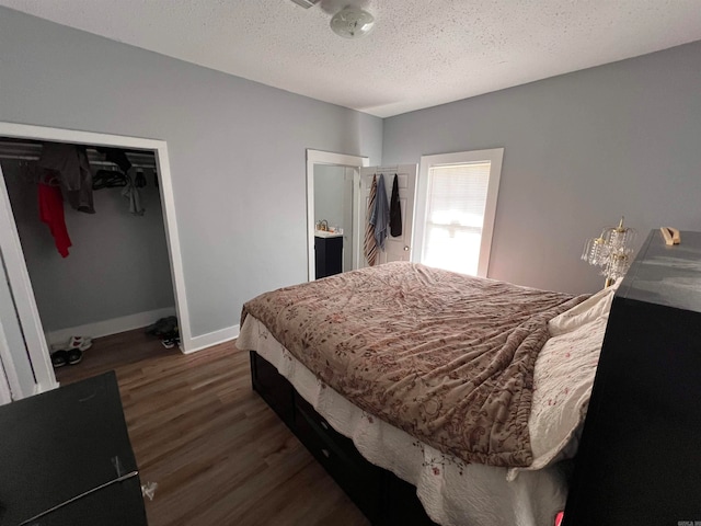 bedroom with dark wood-type flooring and a textured ceiling