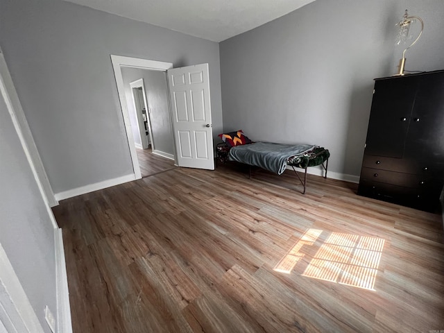 unfurnished bedroom with hardwood / wood-style floors