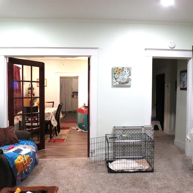 living room with wood-type flooring and crown molding