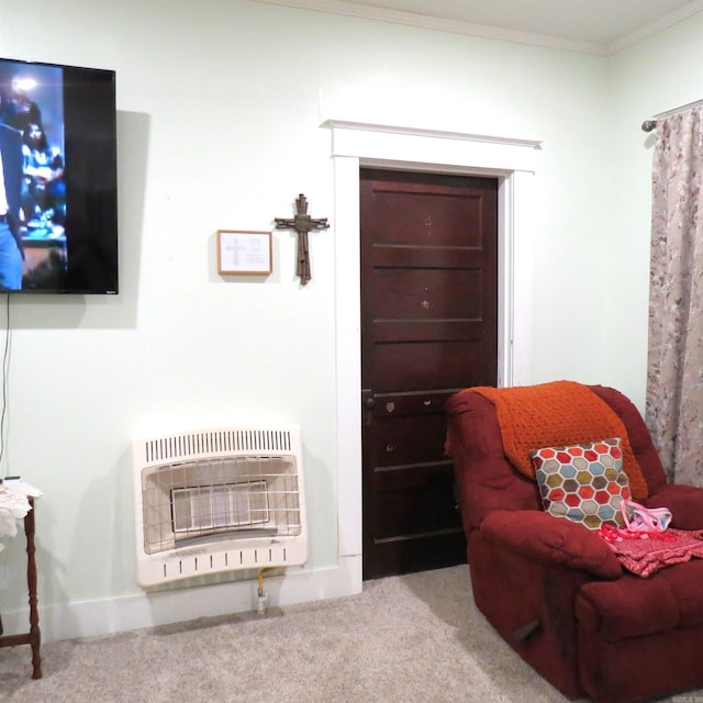 living area with heating unit, light colored carpet, and crown molding