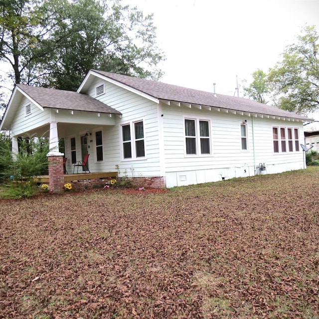 back of property featuring a porch