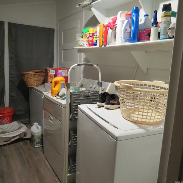 clothes washing area with independent washer and dryer and hardwood / wood-style flooring