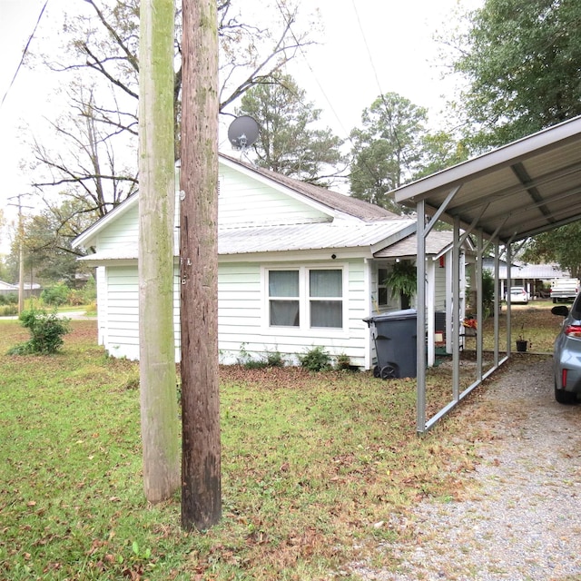 view of property exterior with a carport and a yard