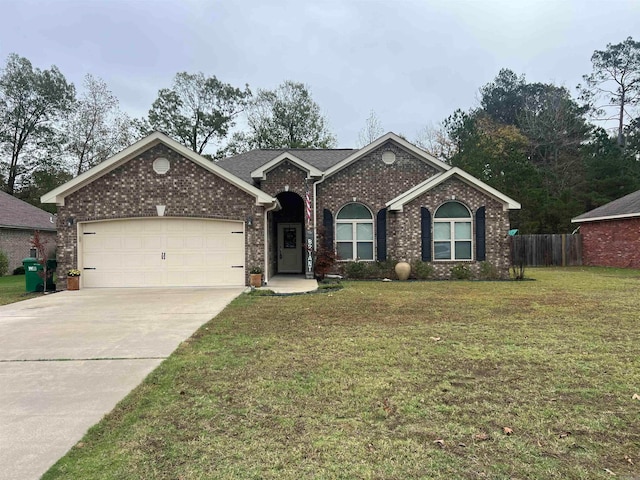 ranch-style house with a garage and a front yard