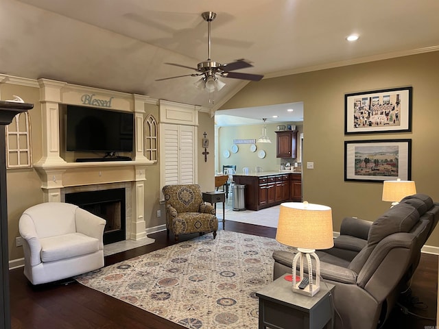 living room featuring ornamental molding, a fireplace, dark hardwood / wood-style flooring, and vaulted ceiling