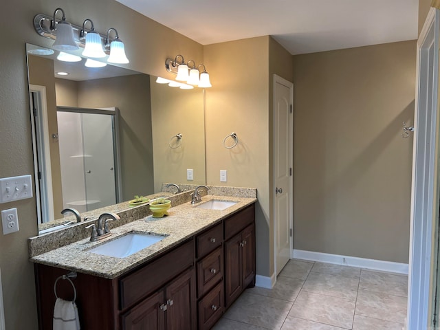 bathroom with walk in shower, vanity, and tile patterned floors