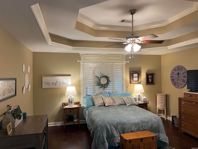 bedroom featuring dark hardwood / wood-style flooring, ceiling fan, crown molding, and a raised ceiling