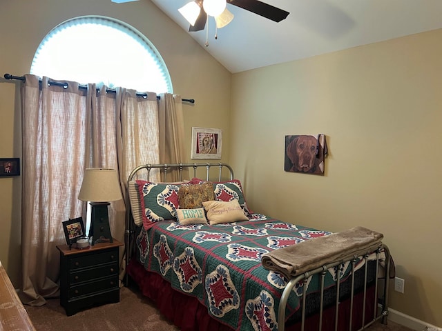 bedroom featuring lofted ceiling, dark carpet, and ceiling fan