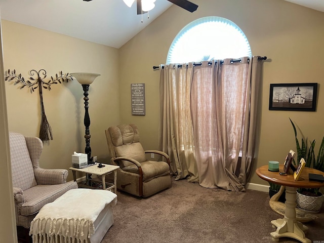 living area featuring carpet flooring, ceiling fan, and vaulted ceiling