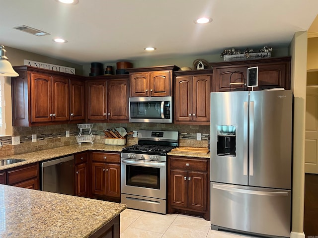 kitchen featuring backsplash, appliances with stainless steel finishes, sink, and light tile patterned flooring