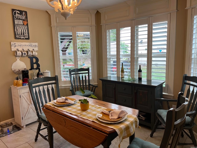 tiled dining room with a wealth of natural light and an inviting chandelier